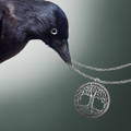 a raven holding the tree of life necklace attached to the metal chain by its beak