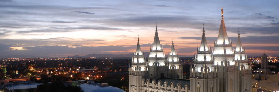 Banner image of the Salt Lake City Temple steeples and city lights.