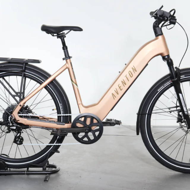 a gold Aventon Level 3 electric commuter bike