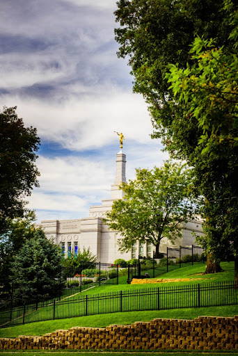 Vertical photo of the Winter Quarters Temple standing on a green hill.