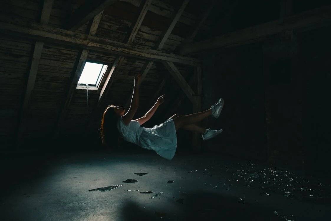 Girl dreaming of falling on gray concrete floor