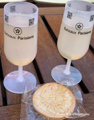 Sip on a glass of champagne and savor a delicious biscuit 