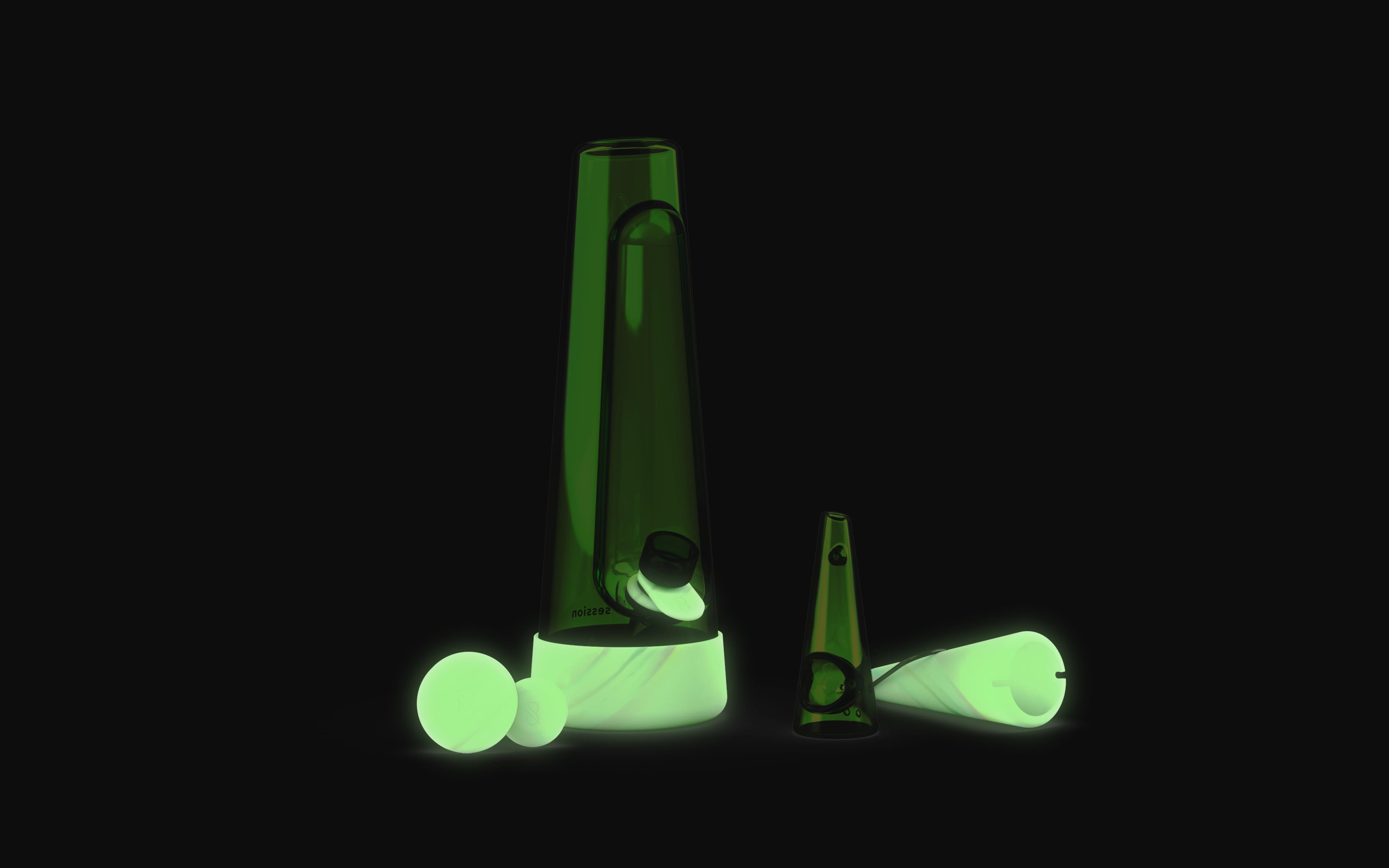green tinted glass bong with a swirled glow-in-the-dark silicone with studio lights off, showing off the glow aspect