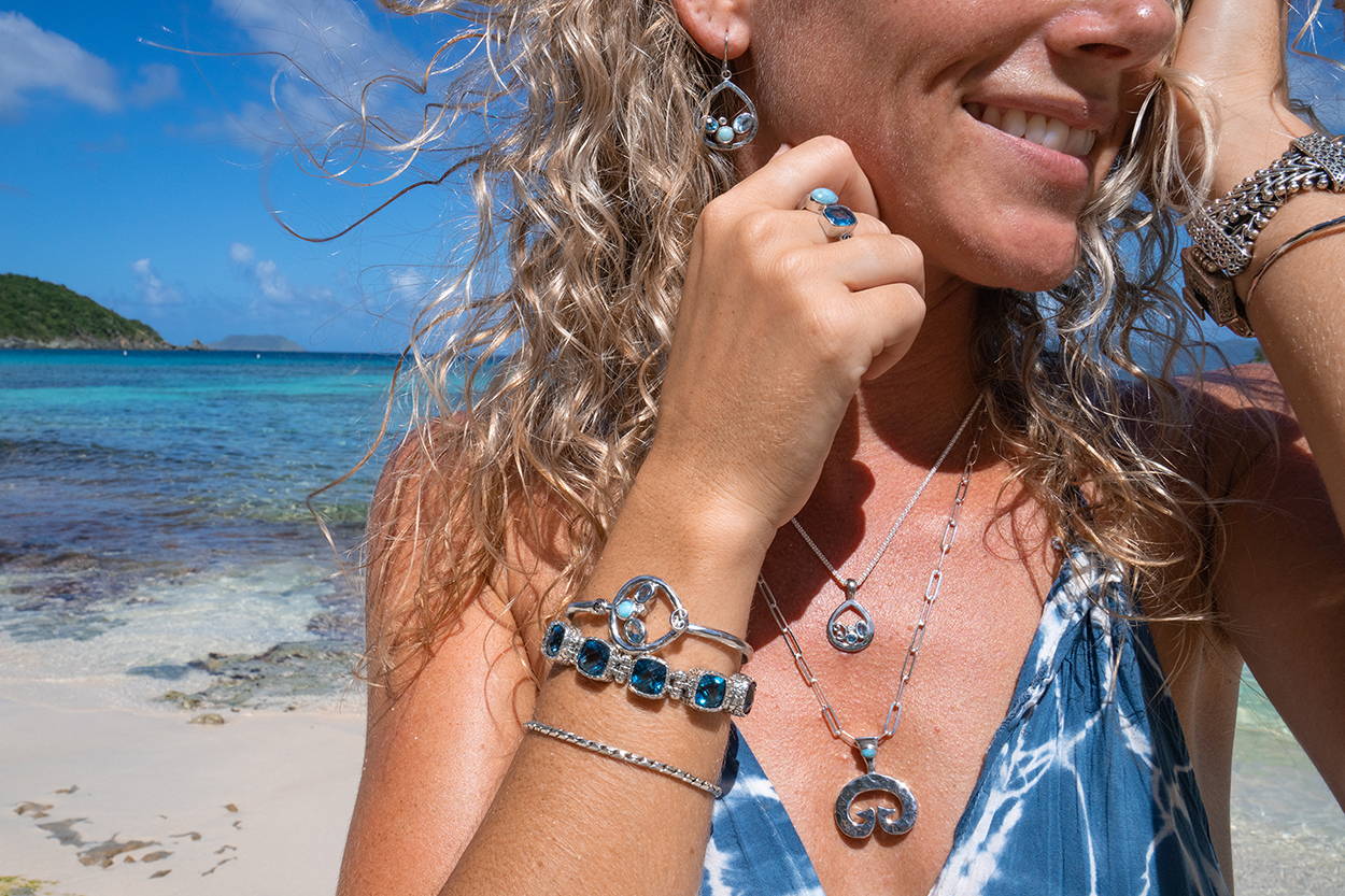Women at the beach wearing gemstone jewelry.