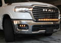 white ram 1500 with off roading light bar on top of bumper