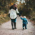 Mother and son walking on a mountain trail.