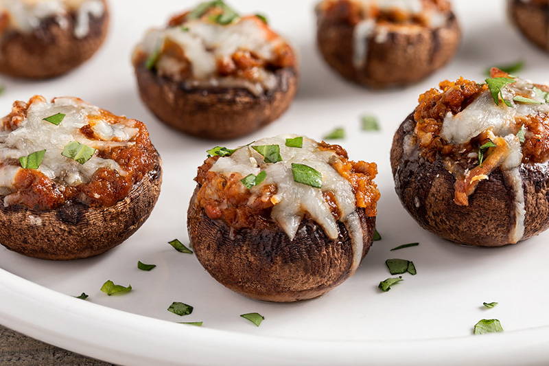 Stuffed mushrooms sprinkled with fresh herbs.