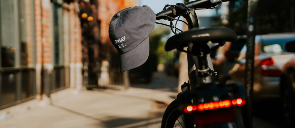 a Rad Power Bikes RadRover with an upway hat hanging off the handlebars