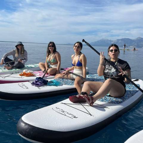 Four girls enjoy inflatable paddleboarding in Canada lake