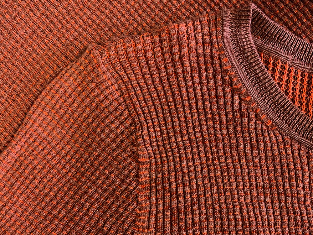 Close up  of a flat lay red waffle knit shirt.