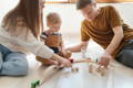 Parents play with the kid.