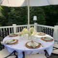 white tablecloth in a round table with an ubrella