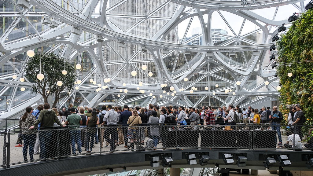 A large crowd listens to Bellwether's investment pitch inside of Amazon's biodome spheres.
