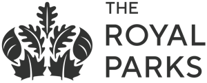 Logo of The Royal Parks features a stylized black crown with leaf motifs on the left, and the words THE ROYAL PARKS in uppercase black letters on the right. The design is simple and elegant.