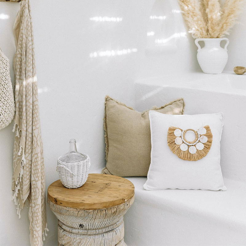 A coastal Boho cushion featuring on a bench and accentuating the boho home decor