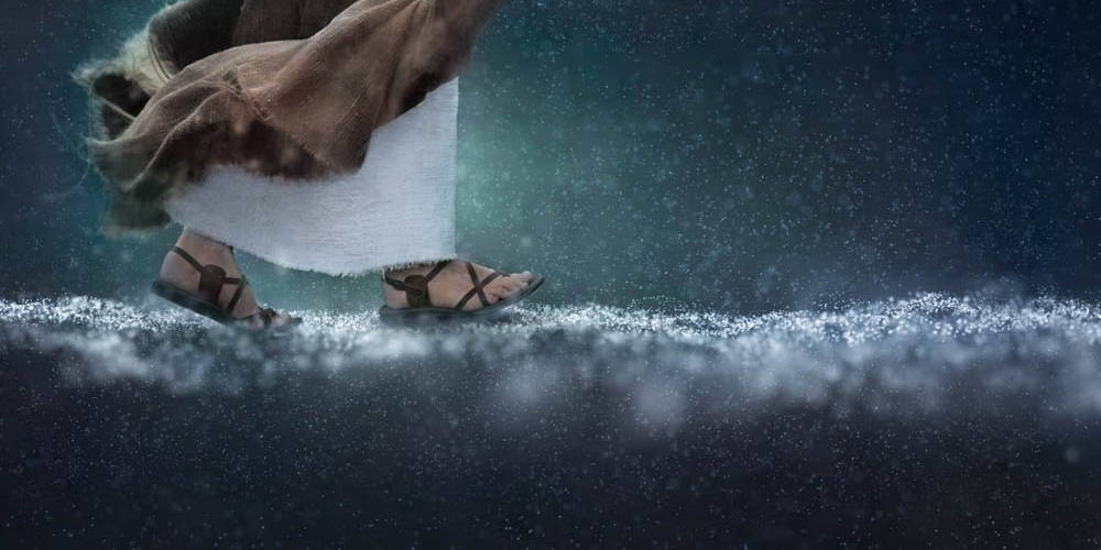 Jesus feet walking through the rain drops across the sea.