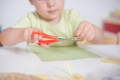 Baby putting a decoration on a birthday cake.