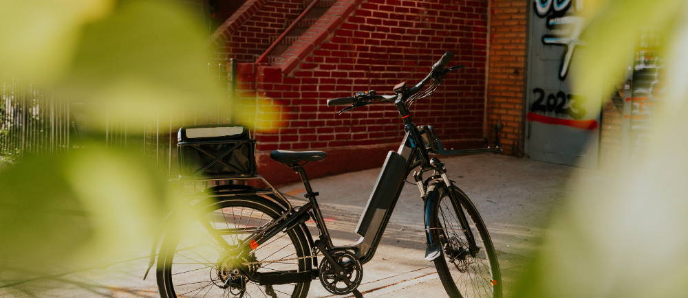 a Rad Power RadRover electric city bike against a brick background