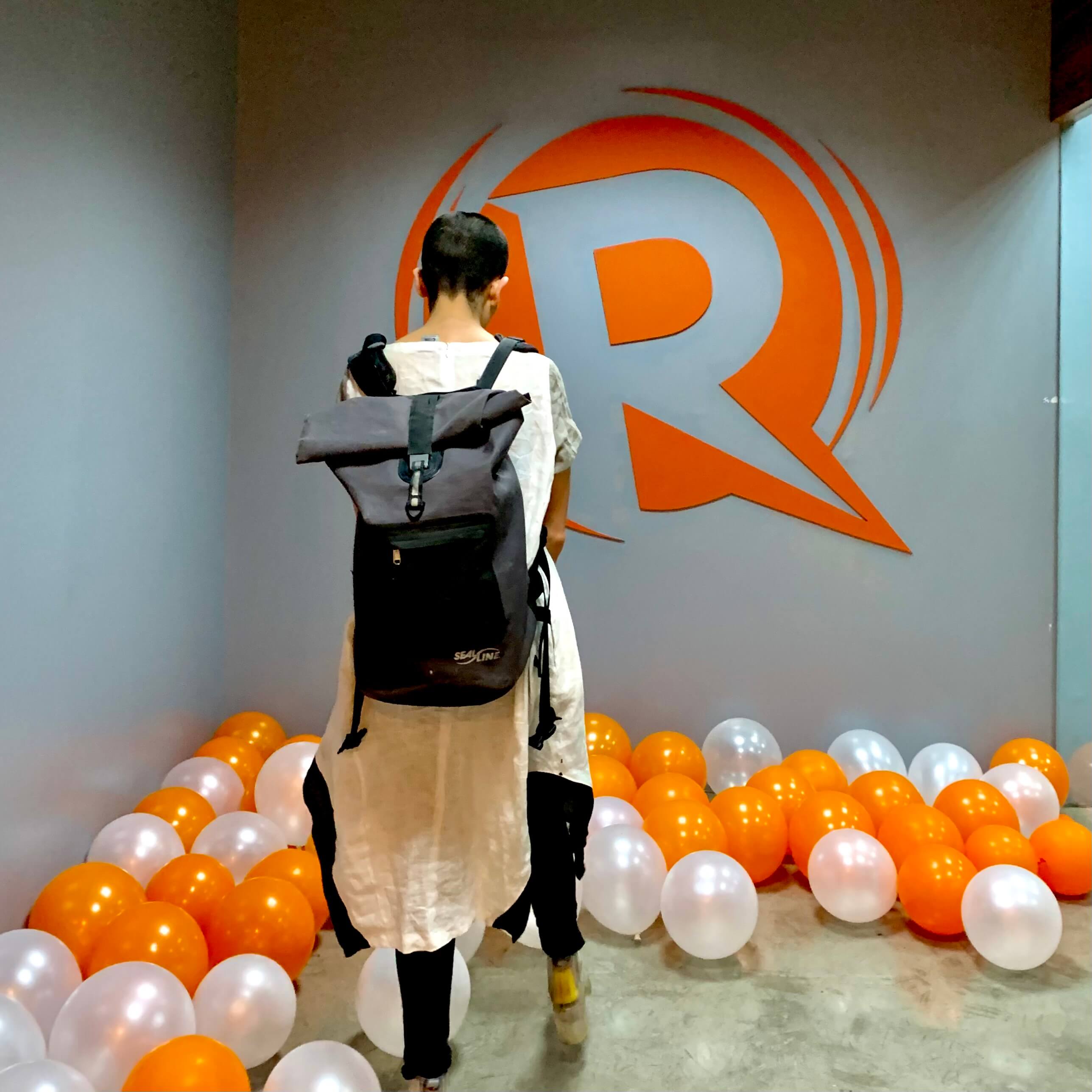 DVXD Director Silvia Gonzalez in front of the Rappler logo outside the entrance to Rappler's office in Manila, Phillipines