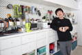 Mechanical engineer, Naoto, laughs during a Cuzen interview, his  tool collection on the wall behind him.