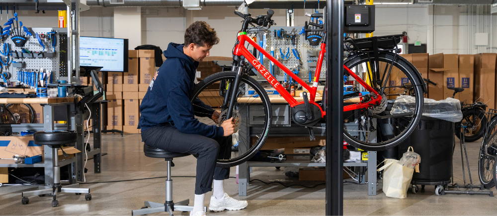 Upway mechanic servicing Gazelle electric bike in repair stand