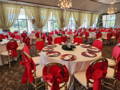 hotel reception of tables with white and red table linens