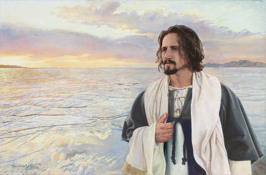 Jesus walking along the shore at sunset.