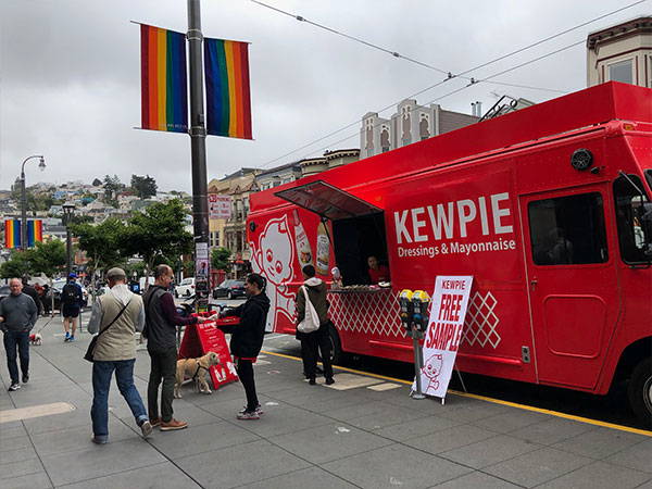 Serving custoers next to Pride flags on Castro street