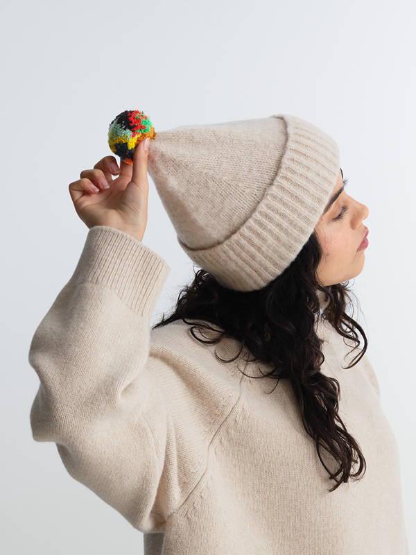 model wears Brushed Plain Hat Stripe Pompom