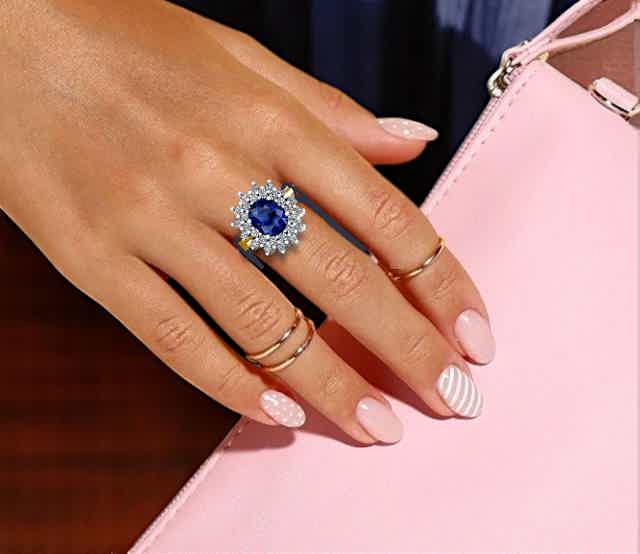 Oval diamond bespoke ring with twin birthstonesPobjoy Diamonds