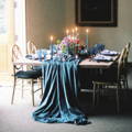 blue table runner over a served table with candles