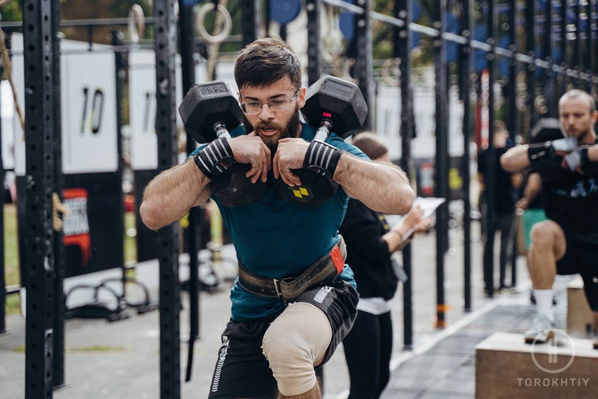 Man in Competition Using Dumbbells Man in Competition Using Dumbbells