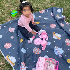 Baby girl playing in park on a splat mat