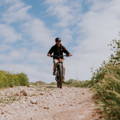 Man riding electric mountain bike on gravel trail