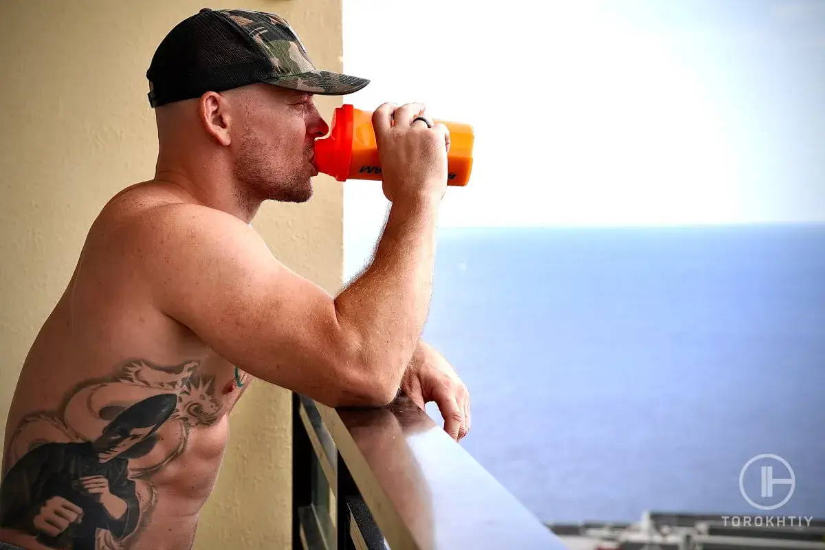 man drinking pre-workout supplemental