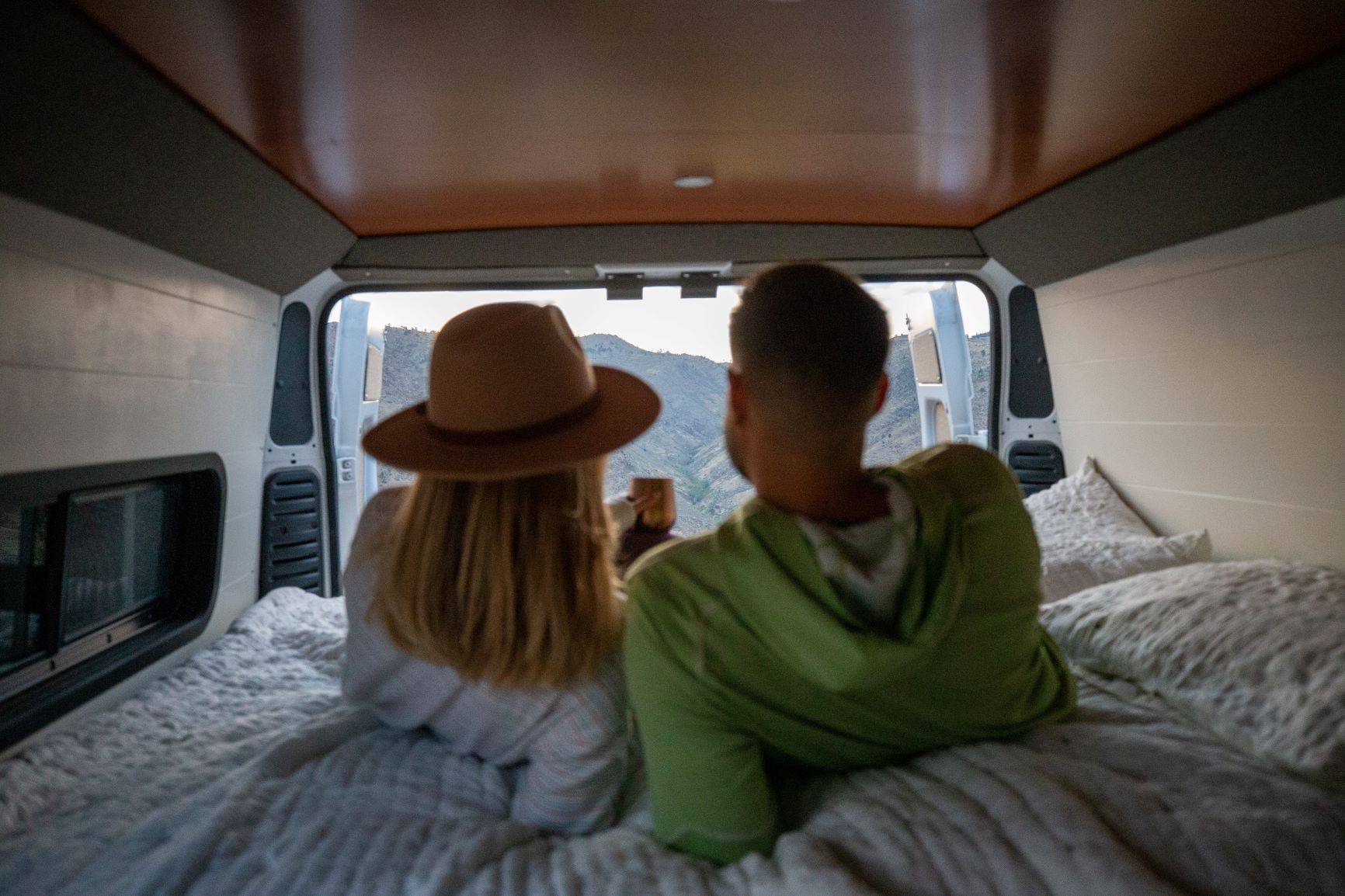 The Bivy - Sprinter 144 / ProMaster 136 Van Conversion - Man and Woman with Great View from Bed - The Vansmith
