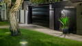 Inground Light by Havit uplighting a tree on the sidewalk, with the facade of the house lit up with wall lights by Havit