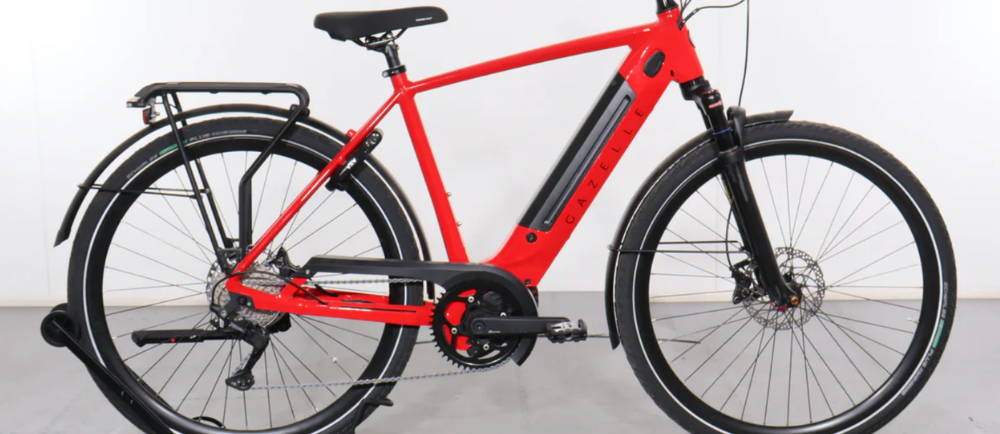 a red Gazelle Ultimate T10+ electric city bike