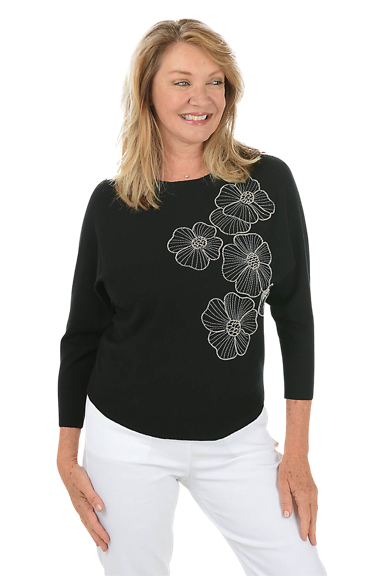 A woman wears a black beaded petunias sleeve sweater.