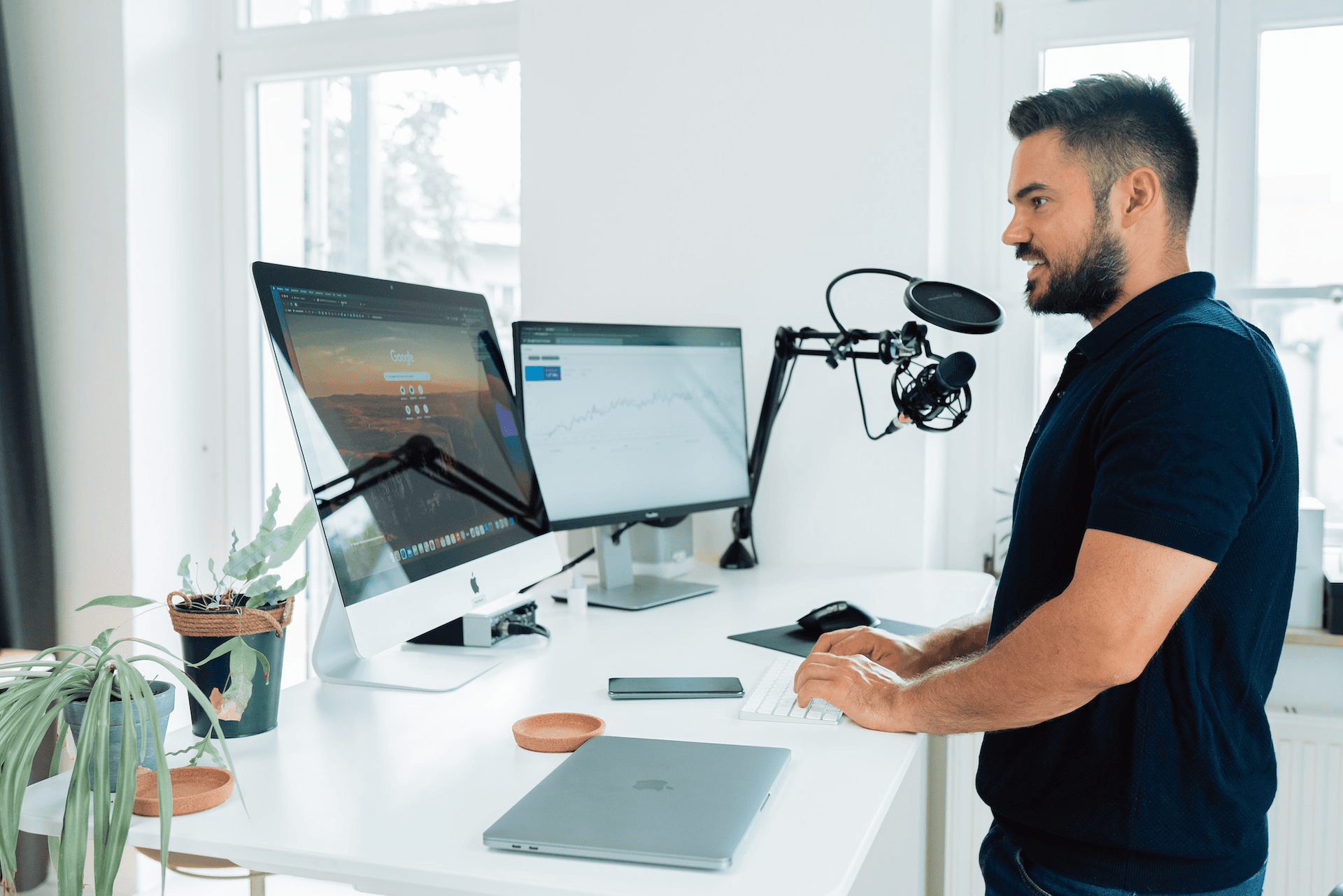 A person setting up a microphone and recording software to start a podcast