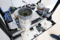 A prototype of theThe Matcha Maker mill is tested with matcha leaves in the workspace of mechanical engineer Naoto.