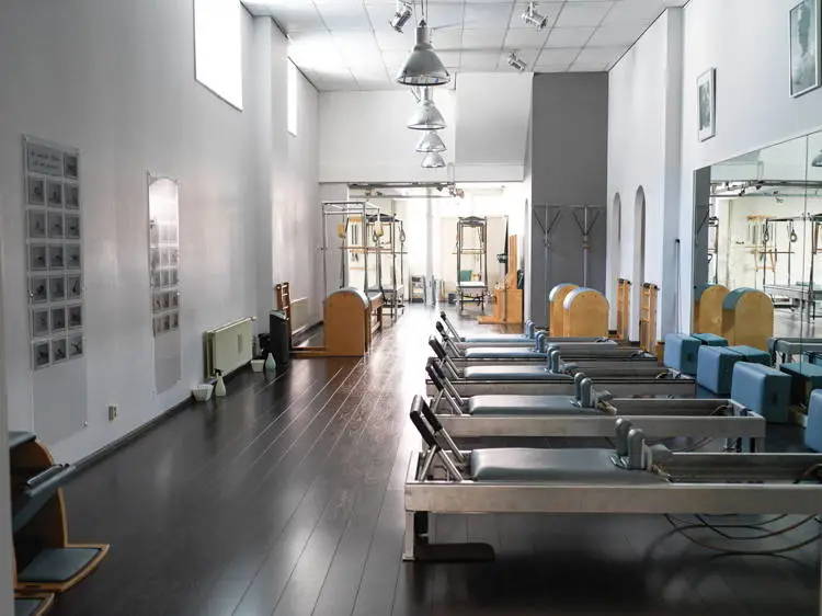 Wide shot of Marjorie Oron's Pilates Studio with Reformers, Ladder Barrels, Pedi Poles, and Wunda Chair