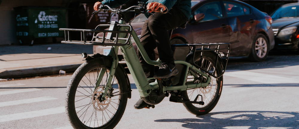 Man riding Momentum PakYak electric cargo bike