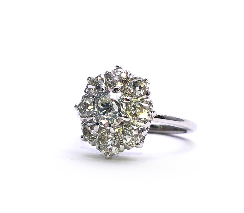 white gold flower ring with nine diamonds