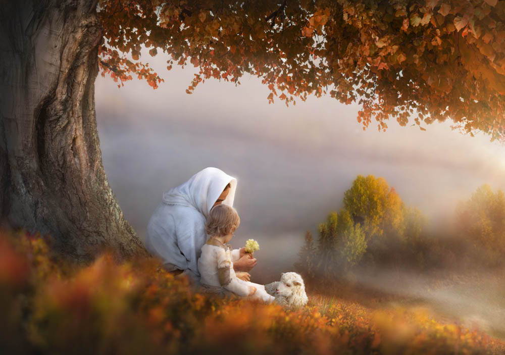 Jesus sitting beneath an autumn tree with a child,  holding a flower. They sit next to a lamb.