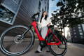 Femme avec son vélo électrique en ville