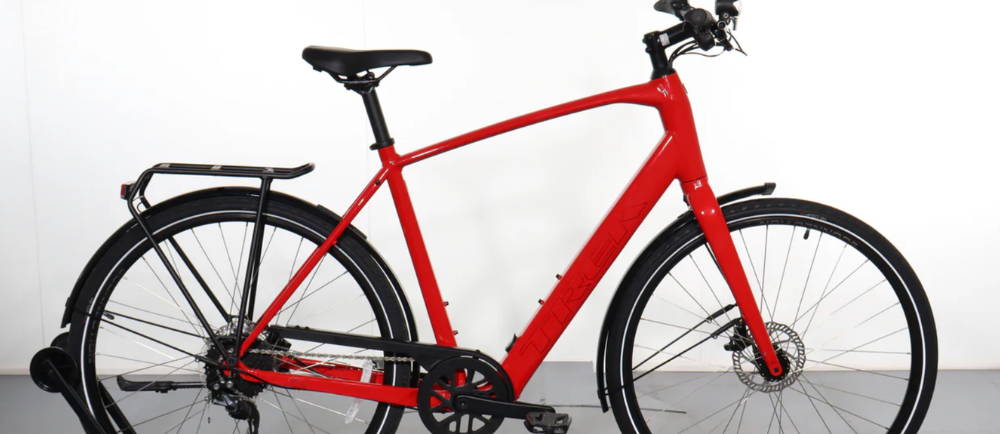 a red Trek FX+2 electric city bike
