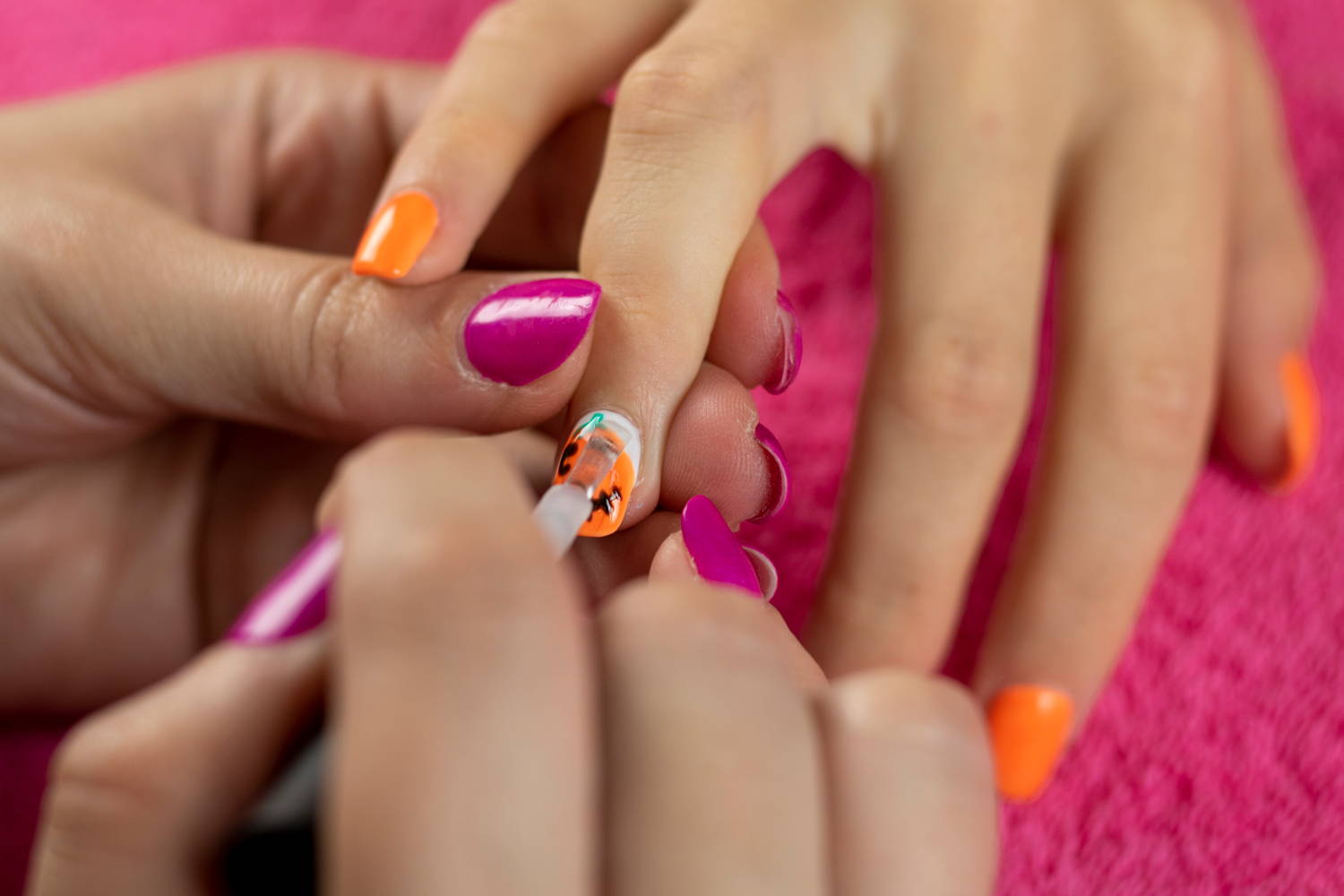 ORLY Glosser Topcoat being painted onto finished pumpkin nails