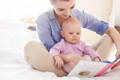 Mother reading to a baby