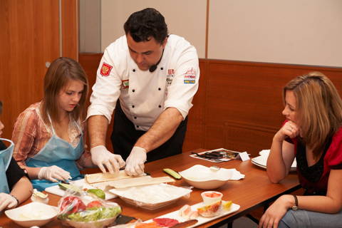 A chef assists in a cooking class